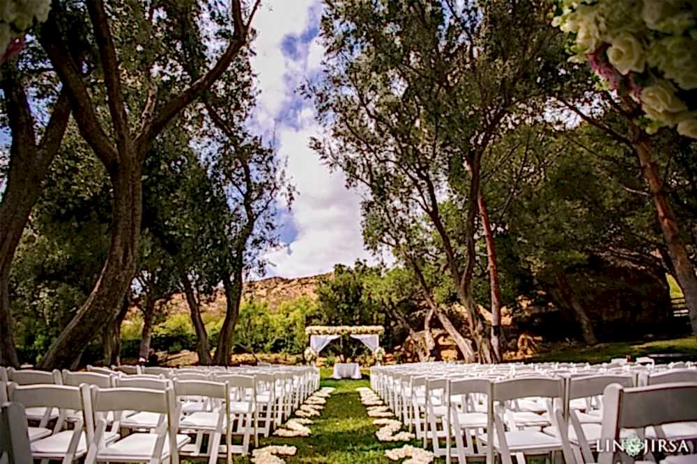 An Orthodox Greek wedding being planned by Orange Blossom Special Events and Lin and Jirsa photography at Hummingbirds Nest Wedding Venue A photo of the stunning venue called Hummingbird's Nest with white chairs and a white wedding canopy in the background
