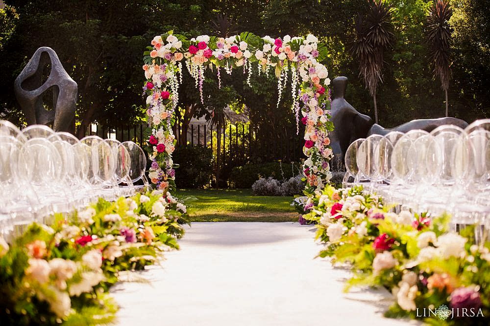 Lavish wedding ceremony with freshly cut white, pink, orange and yellow roses adorning an archway at the San Diego Museum of Art in San Diego, photographed by Lin and Jirsa Los Angeles Lavish wedding ceremony at the San Diego Museum of Art in San Diego, photographed by Lin and Jirsa Los Angeles